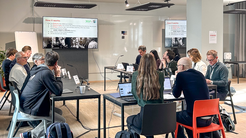 A number of people in a seminar room watching a talk. (Image: Tübingen AI Center)